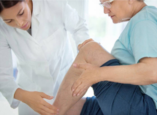A healthcare professional helps a patient with leg exercises, focusing on mobility and rehabilitation