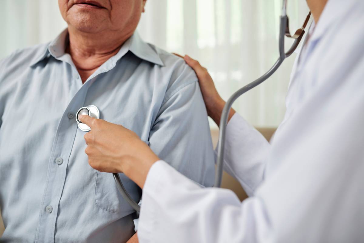 Doctor listening to patient's breathing using a stethoscope